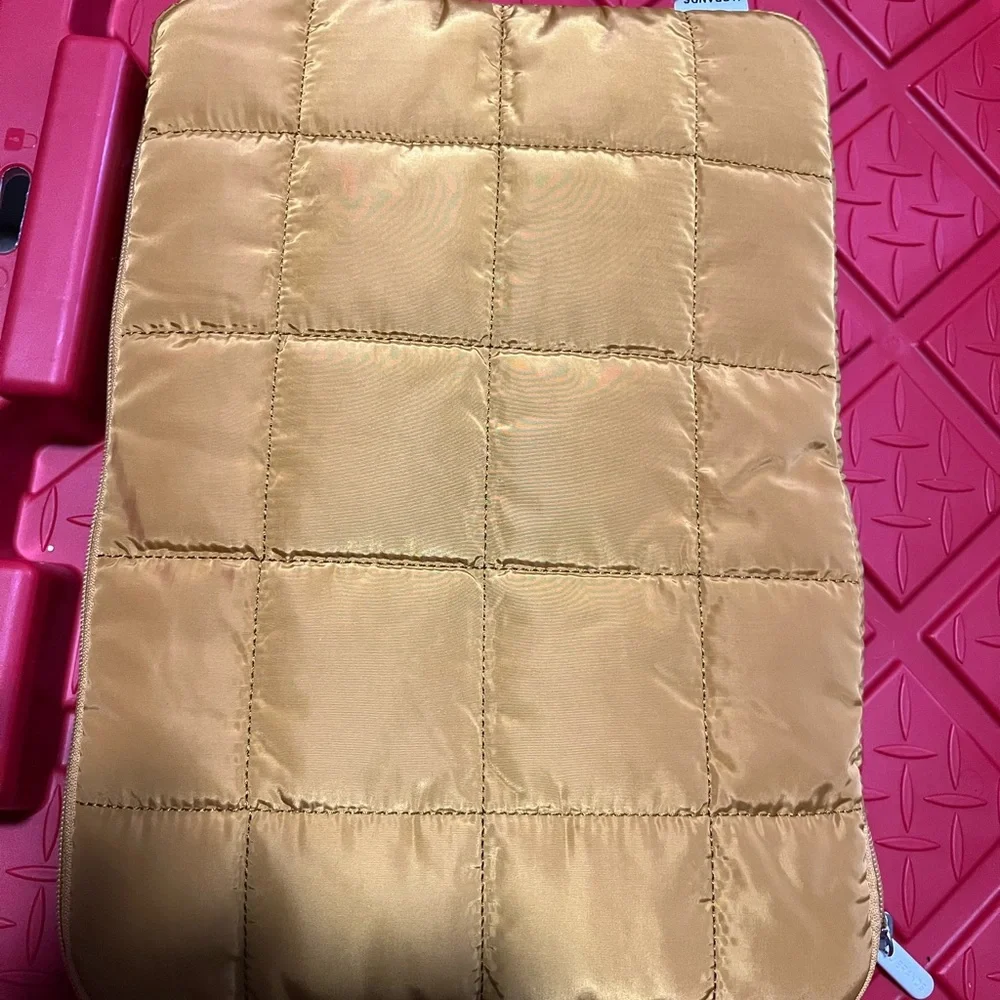 Brand new without tag or box. Laptop Sleeve. Quilted tan/golden plush inside.!